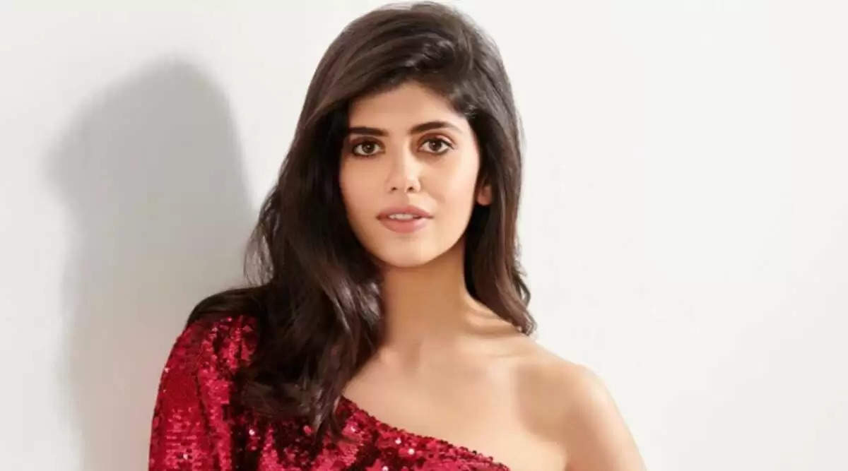 sanjana sanghi in red dress with white background