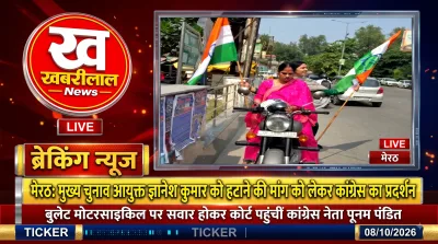 Congress leader Poonam Pandit arrives on a bullet motorcycle during a protest in Meerut